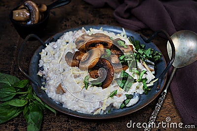 Italian dish risotto with mushrooms, Parmesan and herbs Stock Photo