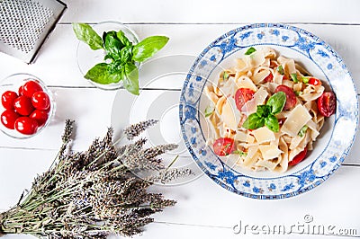 Italian fettuccine pasta with cherry tomatoes and parmesan Stock Photo