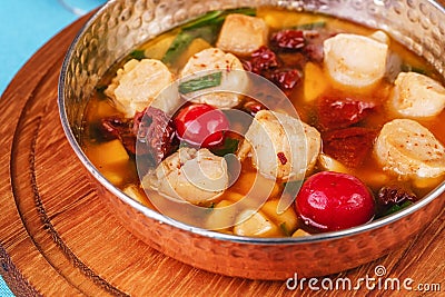 Italian fish soup with tomatoes, dough, dumplings, potatoes and greens. Mediterranean cuisine, European dish Stock Photo