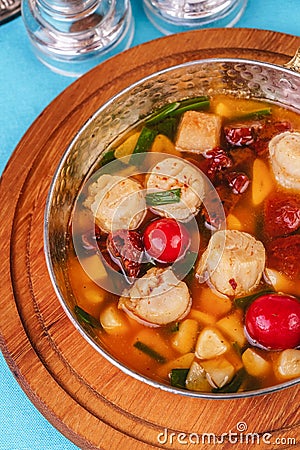Italian fish soup with tomatoes, dough, dumplings, potatoes and greens. Mediterranean cuisine, European dish Stock Photo