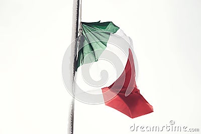 Italian flag flutters in a white landscape and snowy Stock Photo