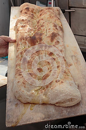 Italian Flat Bread with Oil on Wooden Board Stock Photo