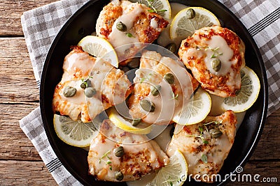 Italian food: chicken piccata with sauce, lemon and capers close Stock Photo