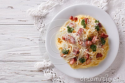 Italian food: pasta carbonara on the table. horizontal top view Stock Photo