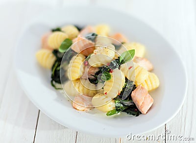 Italian gnocchi pasta with salmon and basil Stock Photo