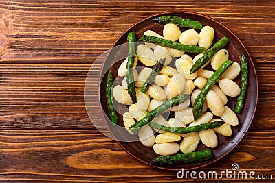 Italian homemade potatoes gnocchi with asparagus Stock Photo