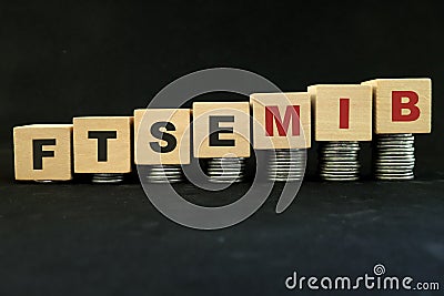 Italian Italy stock market economy growth and recovery concept. FTSE MIB index in wooden blocks with increasing stack of coins Stock Photo