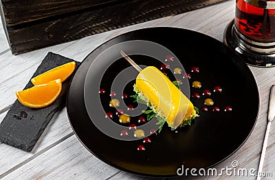 Italian Limoncello dessert on black plate. Lemon cake Stock Photo