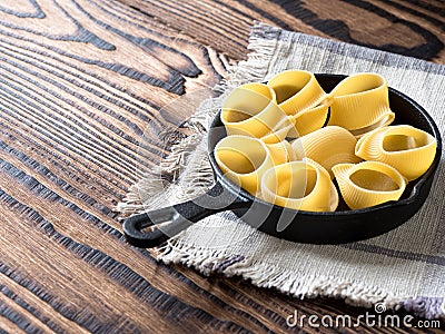 Italian lumaconi pasta in a pan. raw. Stock Photo