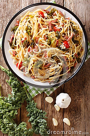 Italian lunch of pasta with cabbage kale, bacon, tomatoes and pa Stock Photo