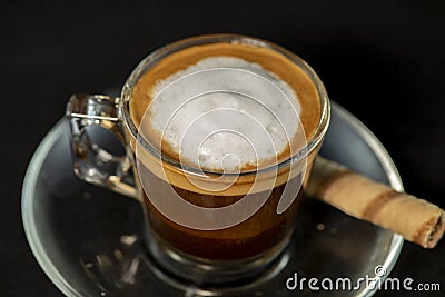 Italian Macchiato coffee with wafer roll Stock Photo