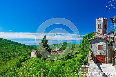 Italian medieval village details, historical stone alley, green coutryside landscape, old city stone buildings architecture. Santa Stock Photo