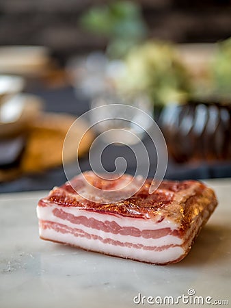 Italian pancetta, seasoned bacon. Pork belly curated meat. Stock Photo