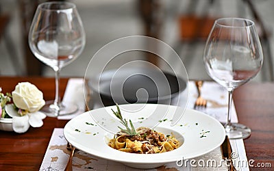 Italian Pappardelle Pasta on an elegant Dining Table Stock Photo