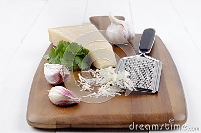 Italian parmesan cheese with garlic, fresh coriander and grater Stock Photo