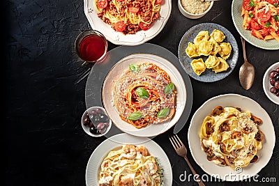 Italian pasta banner design template with copy space. A flat lay of an assortment of pasta dishes with wine and olives Stock Photo