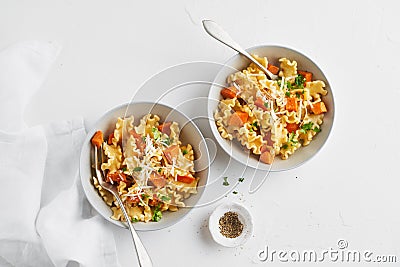 Italian pasta Mafalda Corta trafilata al bronzo with sauteed sweet potato, fennel, parmesan grated cheese on white background. Stock Photo