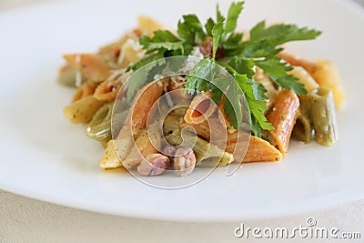 Italian pasta: mezze penne tricolore with pistachios pesto Stock Photo