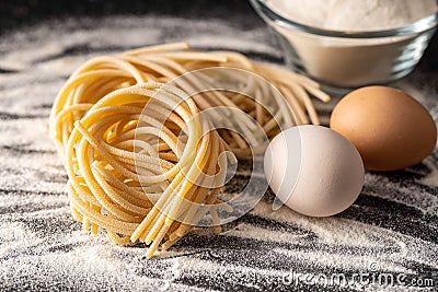 Italian pasta nest. Uncooked spaghetti nest, eggs and flour Stock Photo
