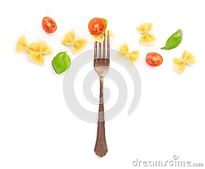 Italian pasta. An overhead photo of a vintage style fork with farfalle, basil, and cherry tomatoes on a white background Stock Photo