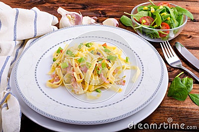 Italian pasta with spring onion and bacon Stock Photo