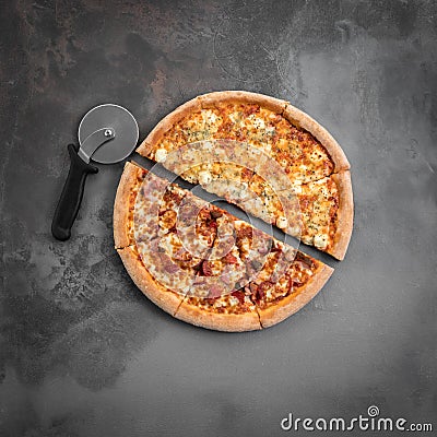 Italian pizza cut in half with cutter on the grey background. Top view and square flat lay photo Stock Photo
