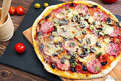 Italian pizza. Delicious fresh baked pizza served on wooden table Stock Photo