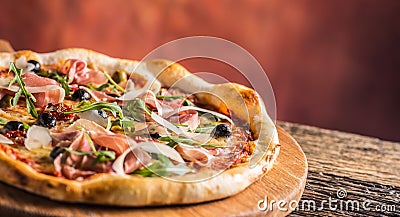 Italian pizza with prosciutto tomatoes olives olive oil parmesan Stock Photo