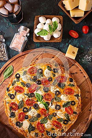 Italian Pizza Wooden Board Ingredients Mazzarella Cheese Basil Spices Black Green View from above Stock Photo