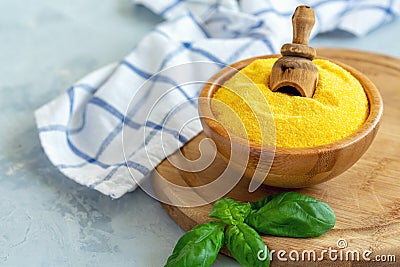 Italian polenta in a bowl and green basil Stock Photo