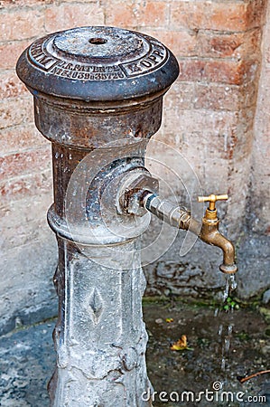 Italian public water fountain in a small village of Italy Editorial Stock Photo