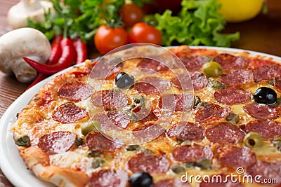 Italian salami pizza on table Stock Photo