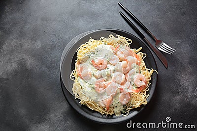 Italian Spaghetti or Pasta with shrimps, garlic and herbs in a creamy Alfredo sauce. Stock Photo