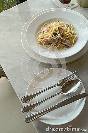 Italian Spahgetti cream source with mushroom and ham serve on white dish in restaurant Stock Photo