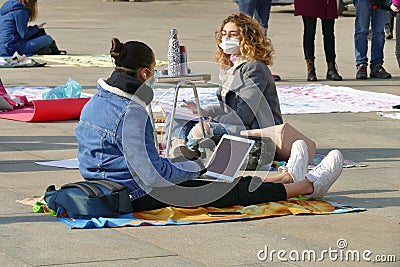 Italian students protest against the government`s choice to close schools by following remote lessons on the sidewalk Editorial Stock Photo