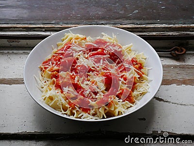 Italian style pasta dish, tomato sauce, porcelain plate Stock Photo