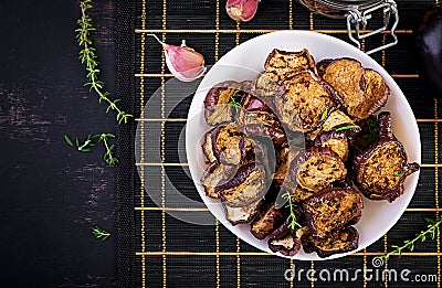 Italian sun-dried eggplant on a dark table. Preserved food. Stock Photo