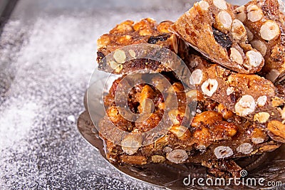 Italian sweet nuts, hazelnuts, almonds, figs, honey dessert over on sugar powder surfase Stock Photo