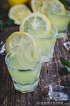 Italian traditional liqueur limoncello with lemon Stock Photo