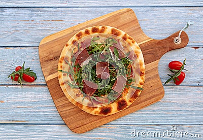 Italian traditional Parma Ham Pizza isolated on wooden table Italian popular food. Top view Pizza Stock Photo