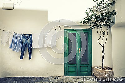 Italian vintage scene. Clothes hanging to dry and old house. Stock Photo