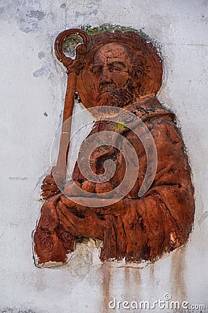 Italy. Bari. Popular devotion. Sculpture of terracotta depicting Saint Nicholas installed on an old city wall. Editorial Stock Photo