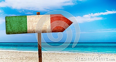 Italy flag on wooden table sign on beach background. It is summer sign of Italy Stock Photo