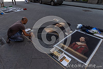 italy, florence 2018 - artist painting a copy of monalisa on a street in florence Editorial Stock Photo