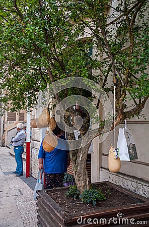 Italy. Matera. Food. Tree with typical hanging cheeses, located next to the entrance door of a traditional food shop Editorial Stock Photo