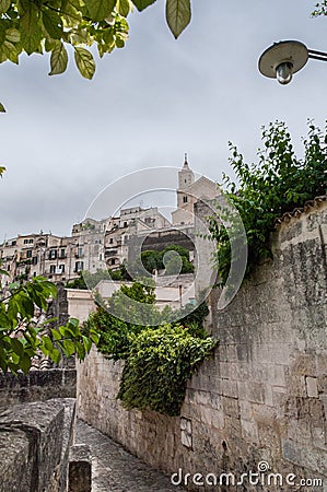 Italy. Matera. Glimpse of Sasso Barisano with the ancient high neighborhood of Civita Stock Photo