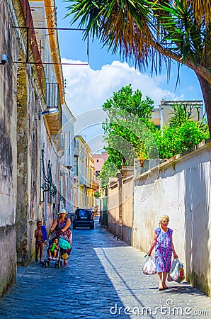 Italy, Napoli, Italian island Procida is famous for its colorful marina, tiny narrow streets with many tourists Editorial Stock Photo