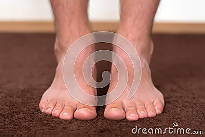 Itchy cold feet resting on the floor. Stock Photo
