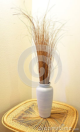 Still Life - Vase and Grass on Wicker Table Stock Photo