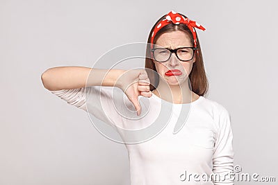 Its bad, sad thumbs down of unsatisfied emotional young woman in Stock Photo